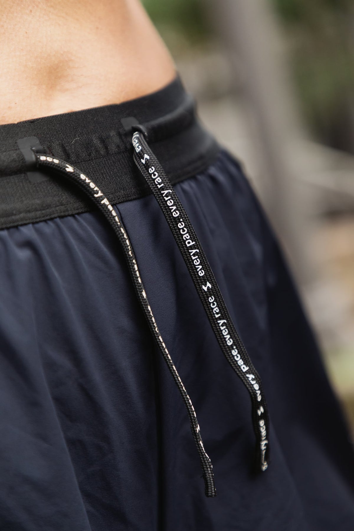 Close detail of the waistband and drawcord on SASH running shorts