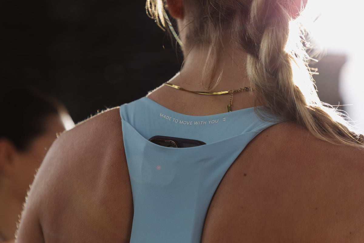 Close back detail of a baby blue SASH performance top