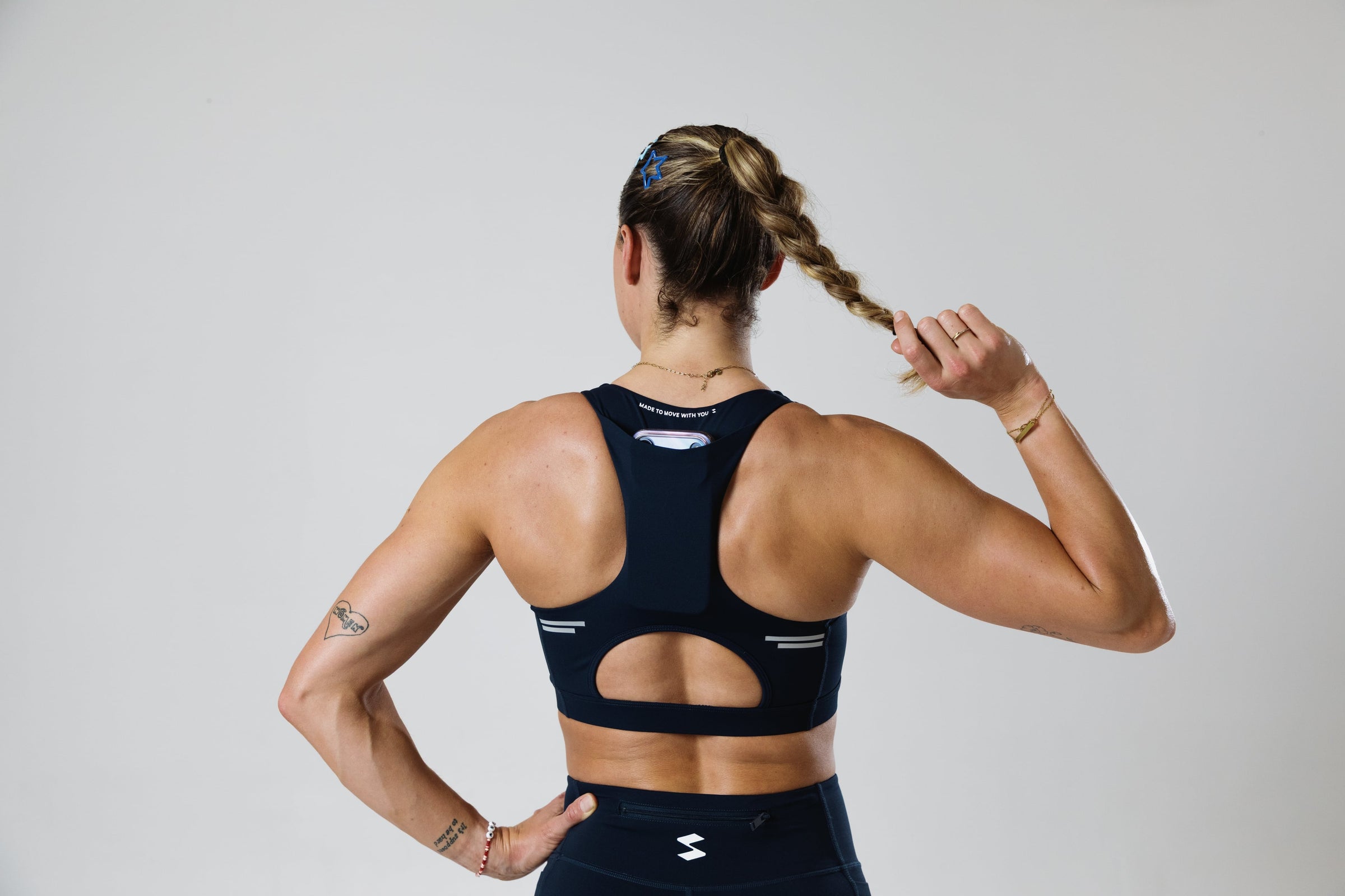 Runner moving in the SASH Navy Blue Perform Bra, rear view